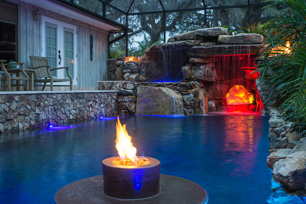 Lucas Lagoons Pool Remodel with elevated spa,  a glowing grotto interior and fire feature in the pool designed and built by Lucas Lagoons for the TV series Insane Pools on Animal Planet