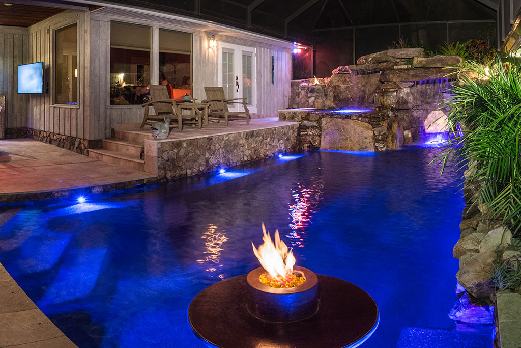 Lucas Lagoons Pool Remodel with elevated spa,  a glowing grotto interior and fire feature in the pool designed and built by Lucas Lagoons for the TV series Insane Pools on Animal Planet