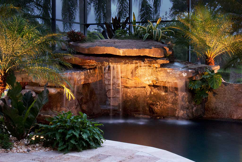 Swimming pool remodel with grotto, spa,waterfalls and a koi pond designed and built by Lucas Lagoons Inc. in Sarasota FL
