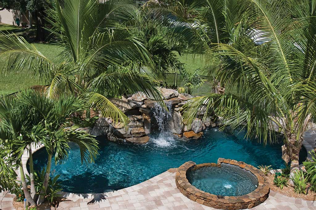 Small lagoon pool with spa and waterfall by Lucas Lagoons Inc.