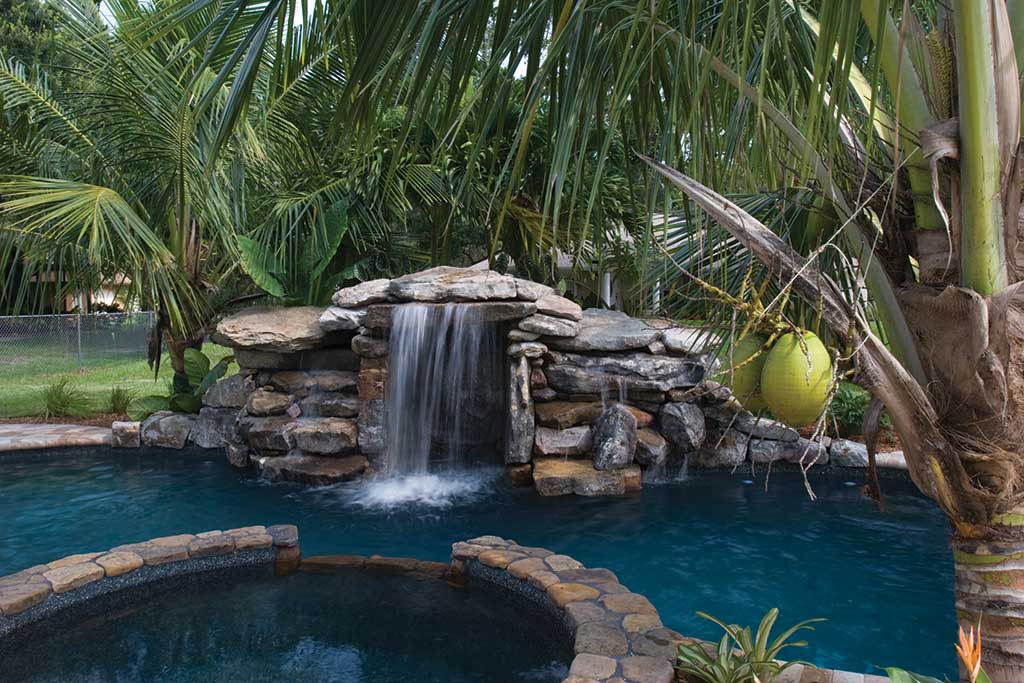Small lagoon pool with spa and waterfall by Lucas Lagoons Inc.