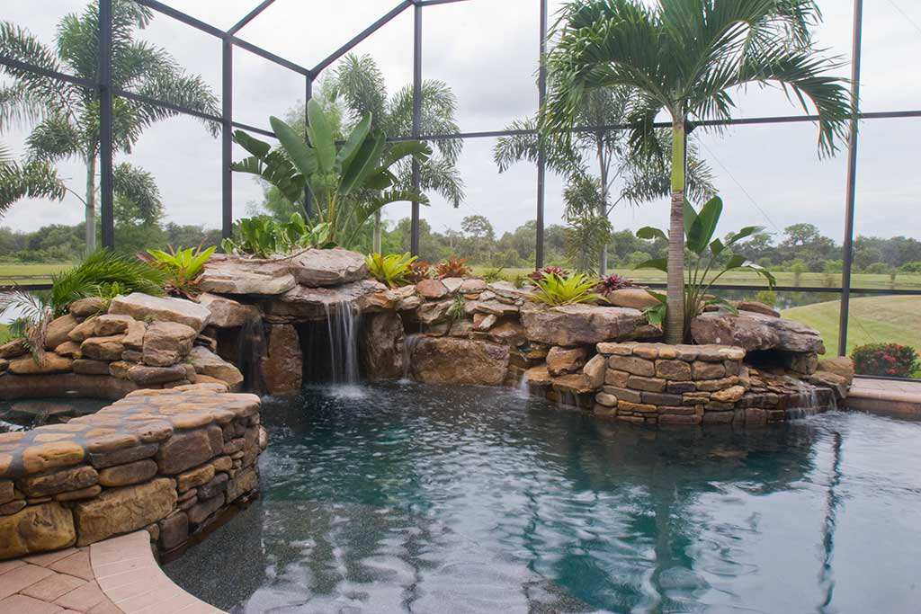 Swimming pool remodel with spa, grotto, multiple water falls by Lucas Lagoons Inc.