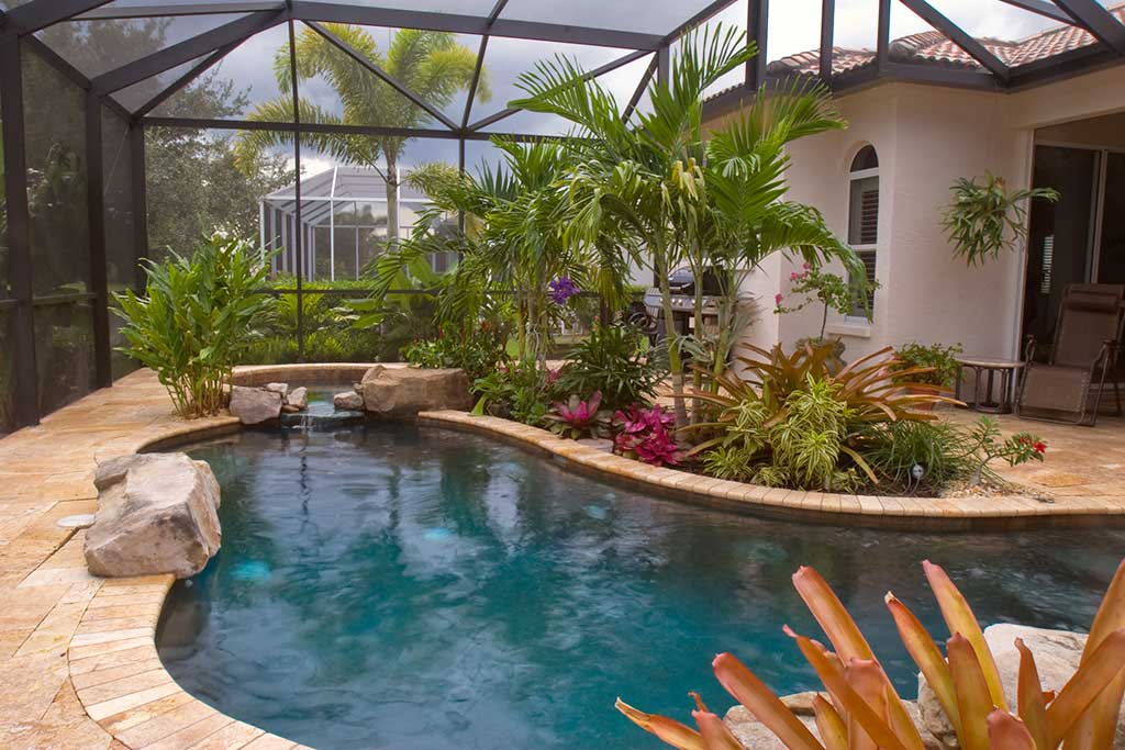 Natural lagoon pool and spa with grotto and waterfall in Bradenton, Florida designed and built by Lucas Lagoons Inc.