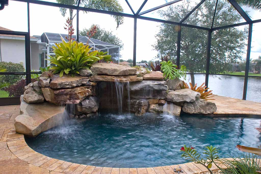 Natural lagoon pool and spa with grotto and waterfall in Bradenton, Florida designed and built by Lucas Lagoons Inc.