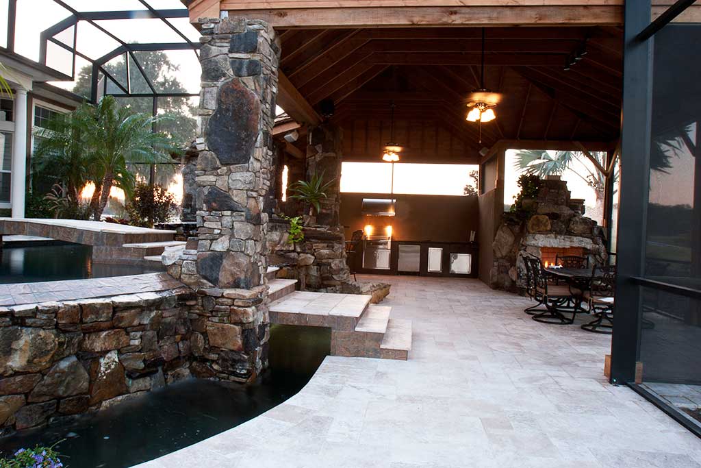 Lagoon pool with spa and infinity edge and a natural stone grotto, swim up barand outdoor kitchen and fireplace