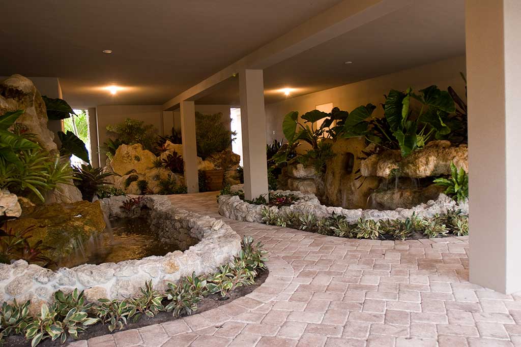 Multiple water features with Florida Limestone and tropical plantings designed and built in Siesta Key Florida by Lucas Lagoons Inc.