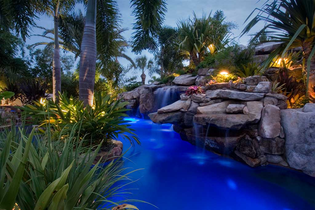 Lagoon Pool and spa with large grotto waterfall and slide designed and built in Nokomis Florida by Lucas Lagoons Inc.