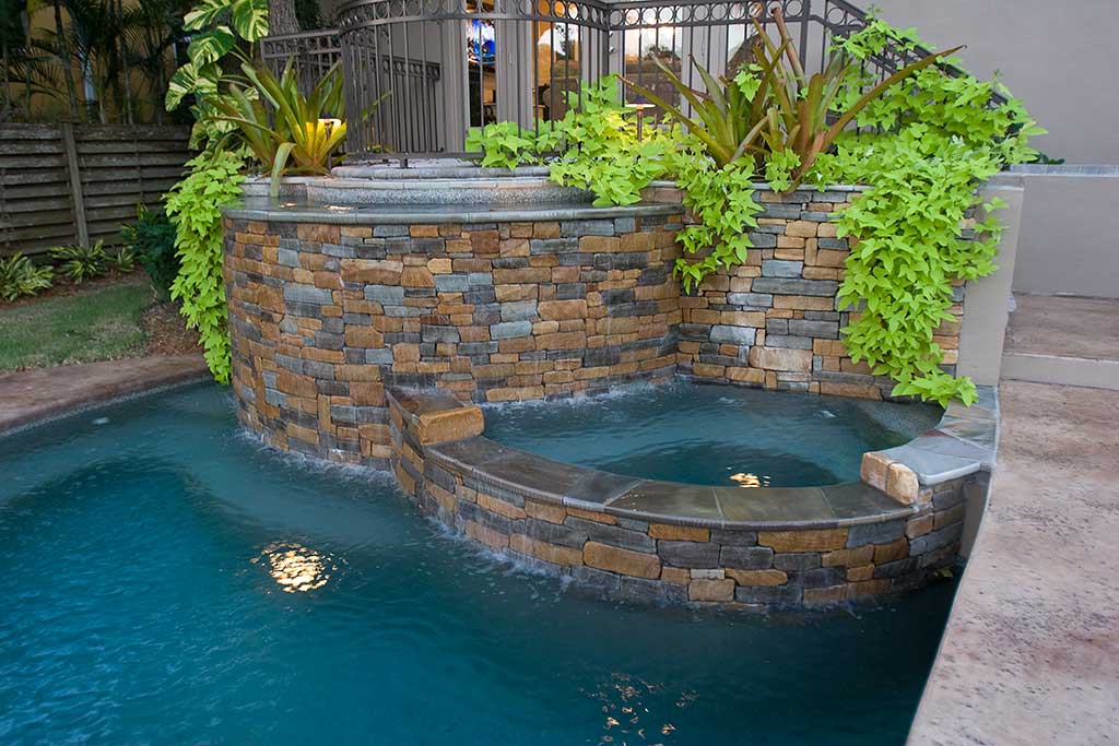 Lagoon pool with spa, bridge, and bar area designed and built in Siesta Key Florida by Lucas Lagoons Inc.