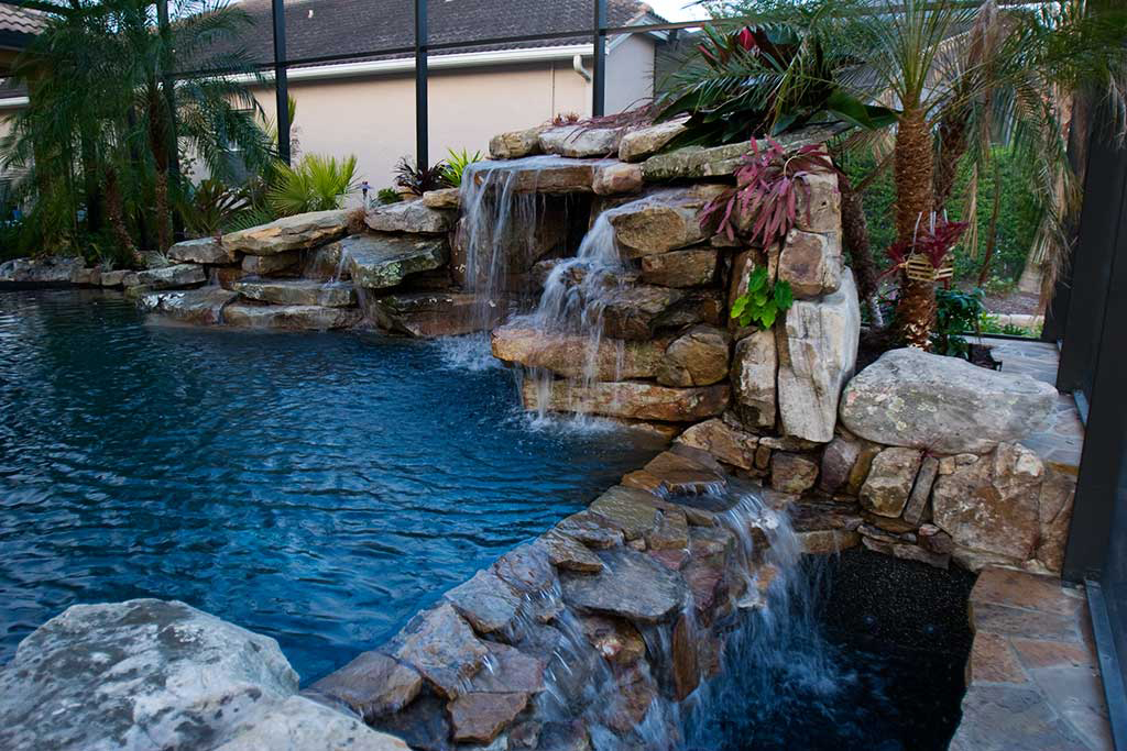 Lagoon pool with grotto waterfall and negative edge designed and built in Palmetto Florida by Lucas Lagoons Inc.