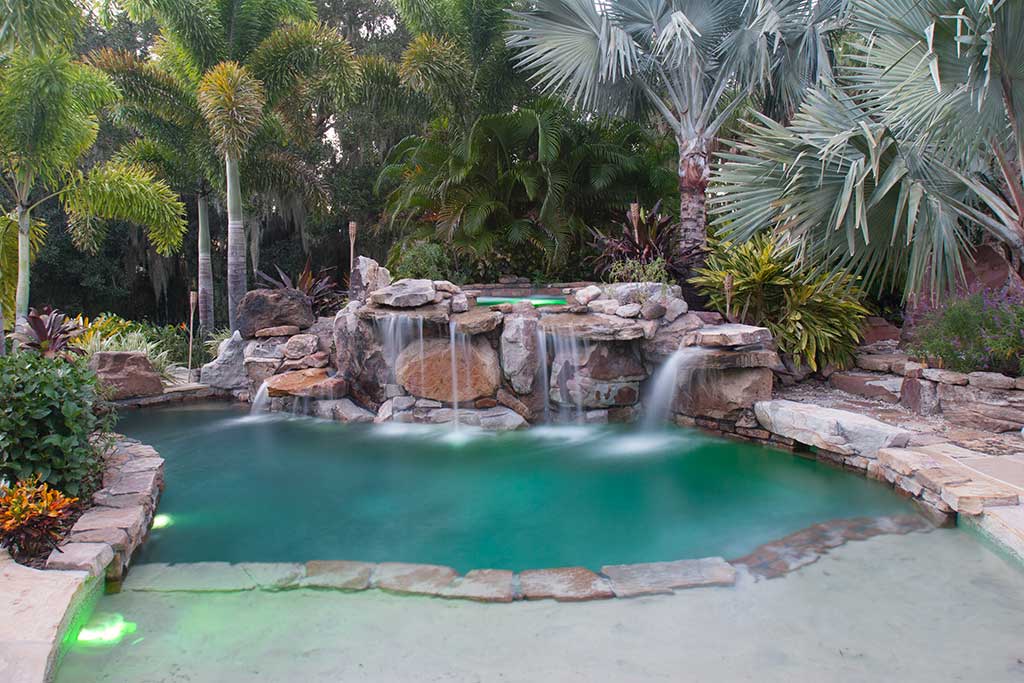Lagoon Pool with grotto and elevated spa waterfall by Lucas Lagoons Inc.