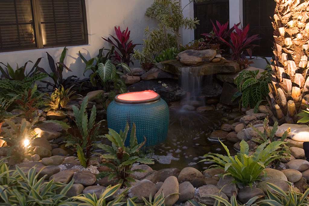 Water feature and fire pit designed and built in Bradenton Florida by Lucas Lagoons Inc.