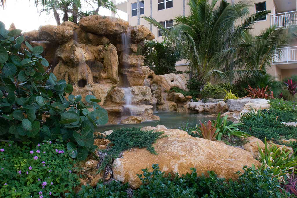 Natural Limestone water feature at entrance to Longboat Key Club by Lucas Lagoons Inc.