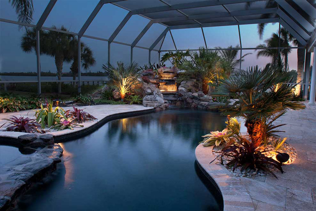 Lagoon Pool remodeled by changing shape of swimming pool from linear to naturally curving lagoons style and adding spa and waterfall and planters designed and built in Osprey, Florida by Lucas Lagoons Inc.