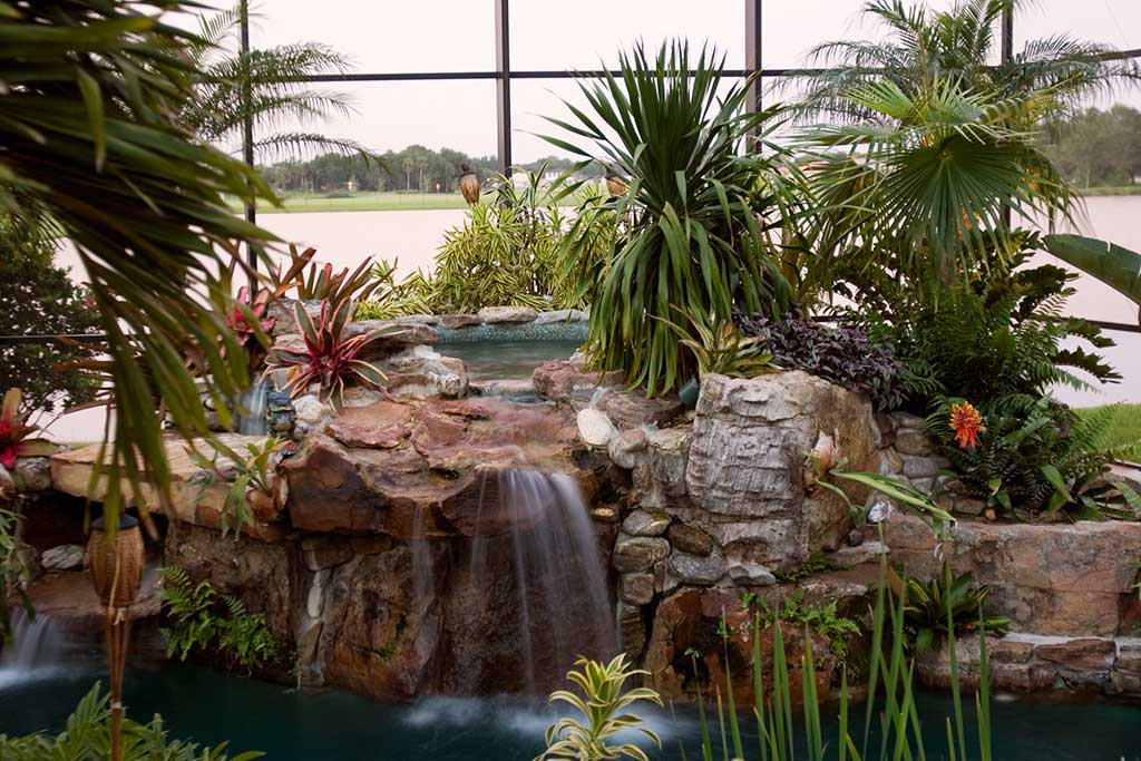 Lagoon pool with elevated spa and waterfall surrounded by Natural Tennessee Fieldstone with a beach areas and swim up bar designed and built by Lucas Lagoons Inc.