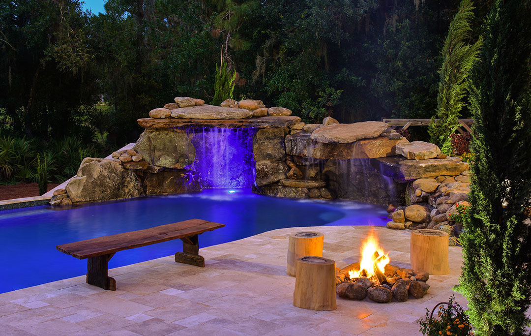 Natural Stone Grotto, Lagoon pool, travertine deck and fire pit designed and built by Lucas Lagoons Inc. for the TV Series Insane Pools on Animal Planet