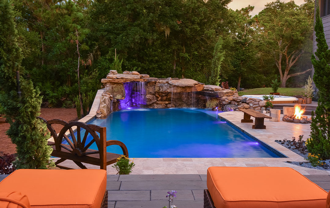 Natural Stone Grotto, Lagoon pool, travertine deck and fire pit designed and built by Lucas Lagoons Inc. for the TV Series Insane Pools on Animal Planet