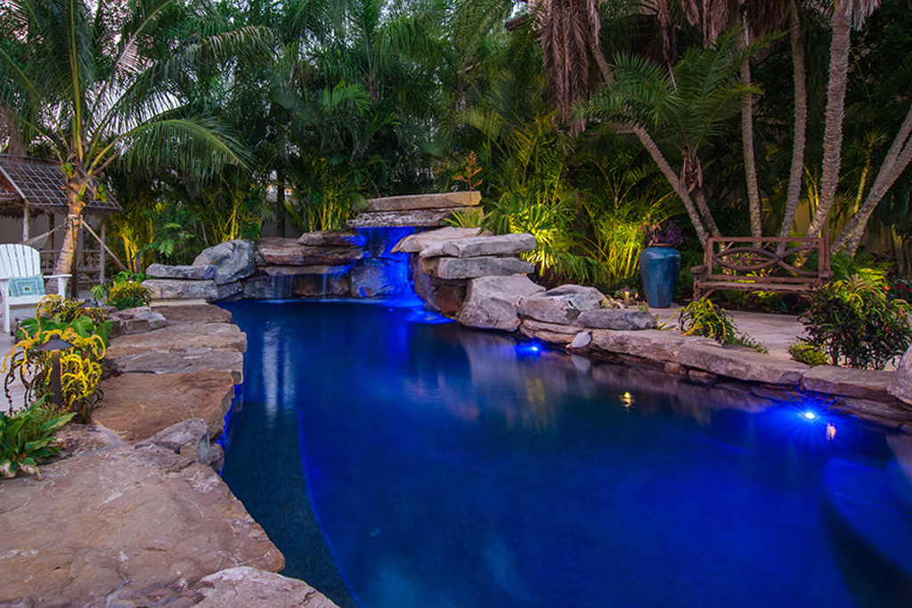 Lucas Lagoons pool with rock grotto, rock bridge, travertine deck and Koi pond as seen on Insane Pools: off the deep end