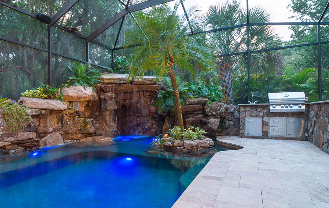 Lucas Lagoon Pool and spa remodel with Waterwalls, Natural Stone grotto and outdoor kitchen designed and built by Lucas Lagoons for the TV show Insane Pools on Animal Planet
