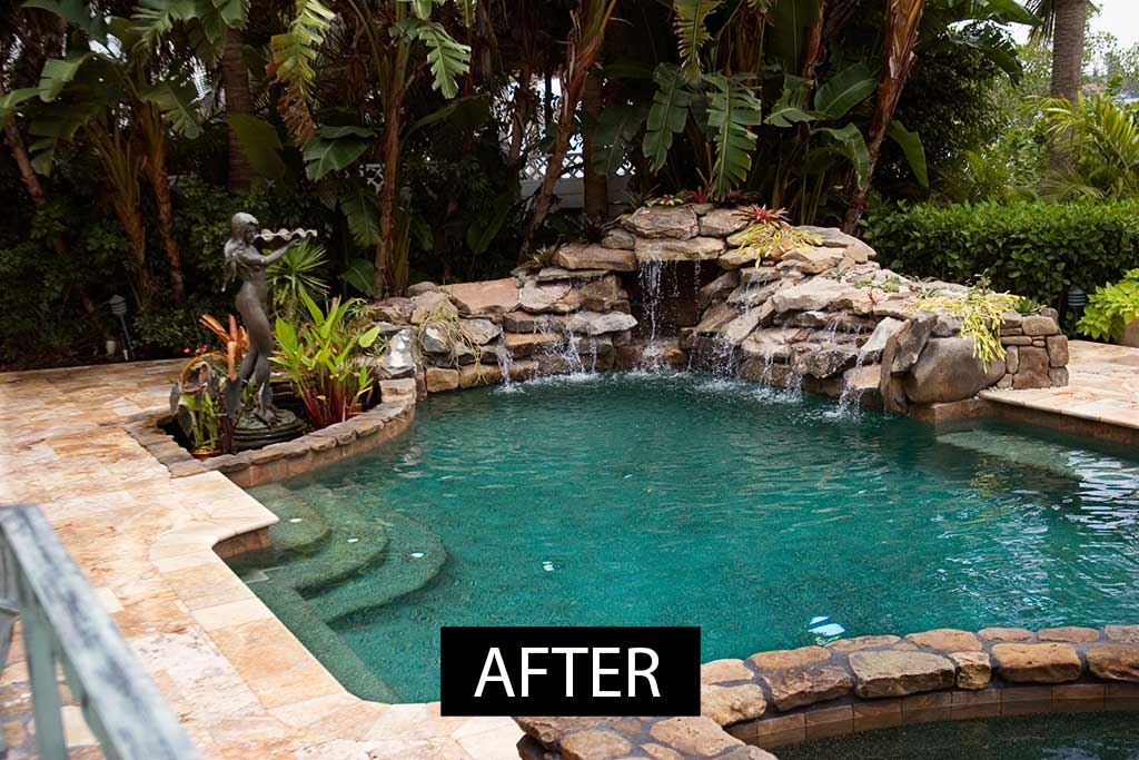 Lagoon pool remodel with natural stone waterfall, large travertine deck and stone veneered wall designed and built by Lucas Lagoons Inc.