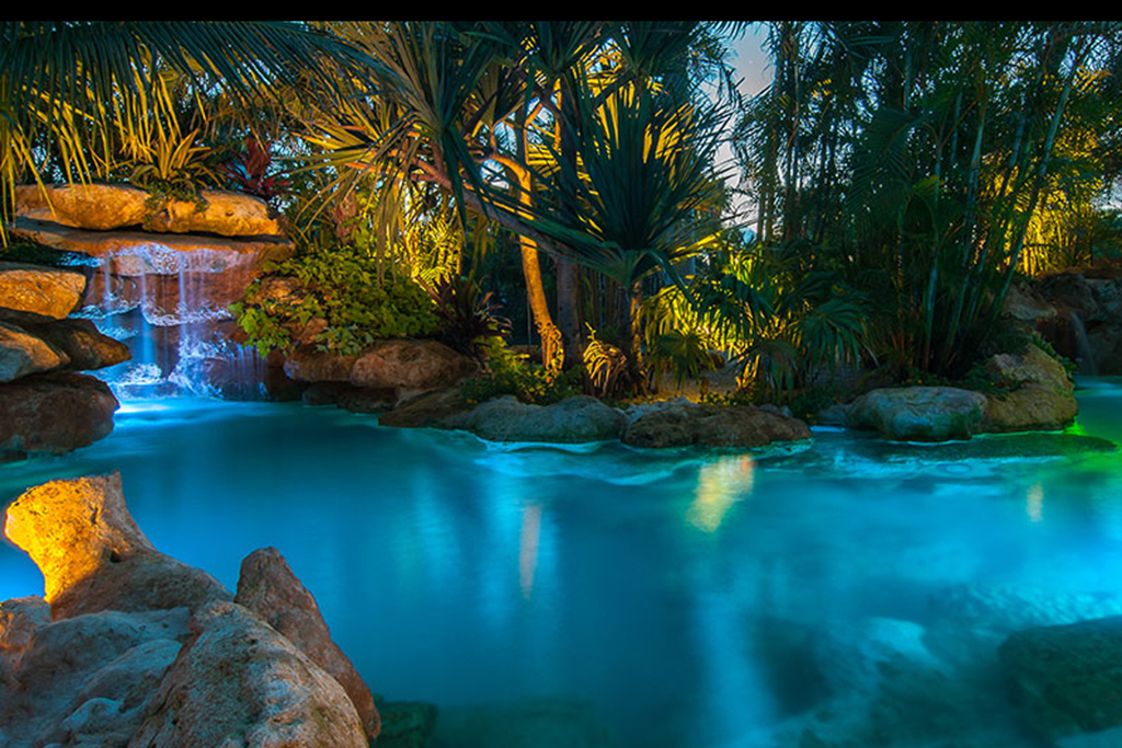 Palm Island lagoon and spa with Florida Limestone waterfalls and Grottos and tropical landscaping 