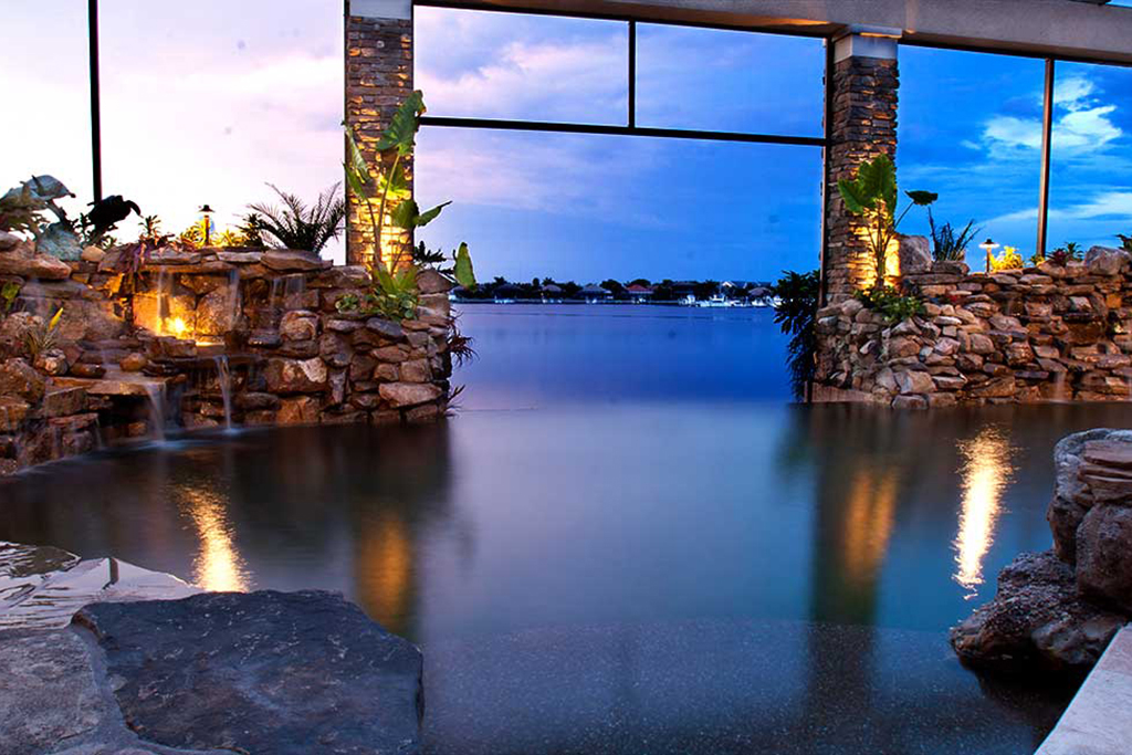 Lagoon pool remodel with an infinity edge and multiple waterfalls built with Natural Tennessee Field stone designed and built in Palmetto Florida by Lucas Lagoons Inc.