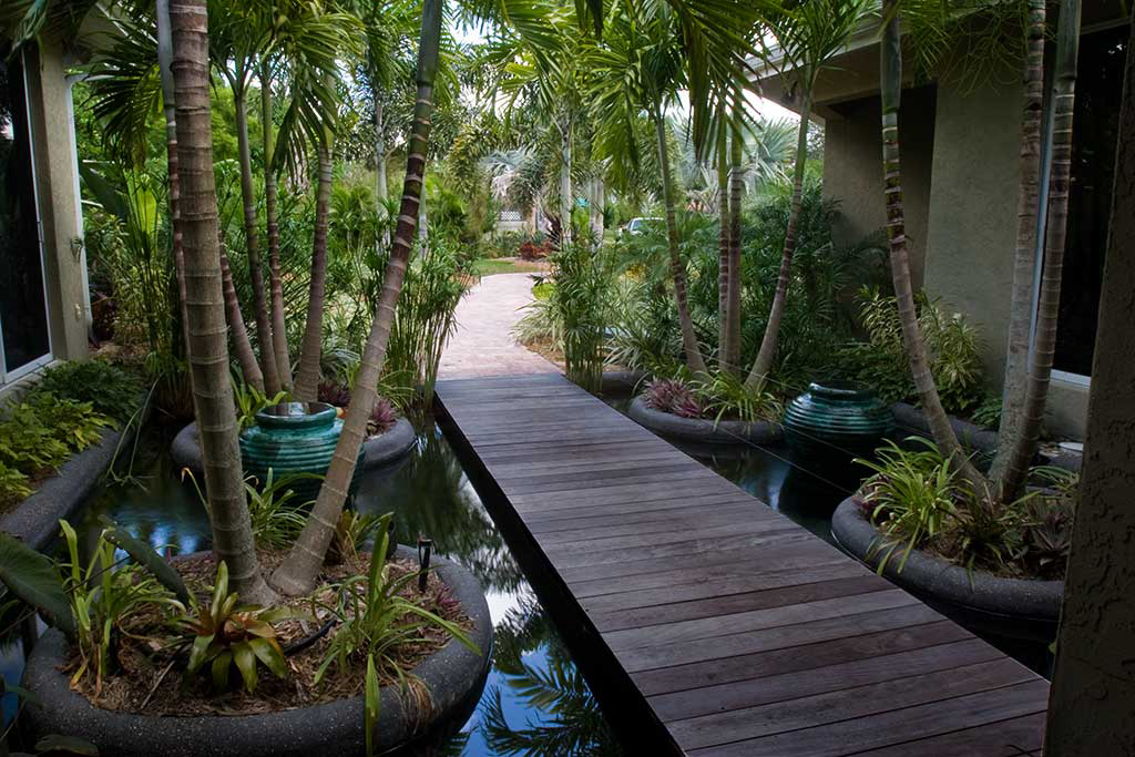 Entry feature with bridge over water  designed and built in Osprey Florida by Lucas Lagoons Inc.