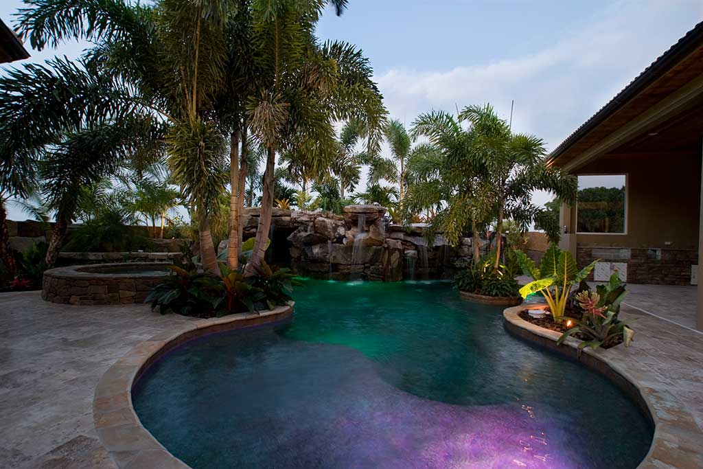 Lagoon pool and spa with natural Tennessee field stone grotto water feature, in Sarasota, Florida designed and built by Lucas Lagoons Inc.